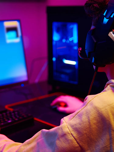 a person playing a video game and wearing a headphone Mobile