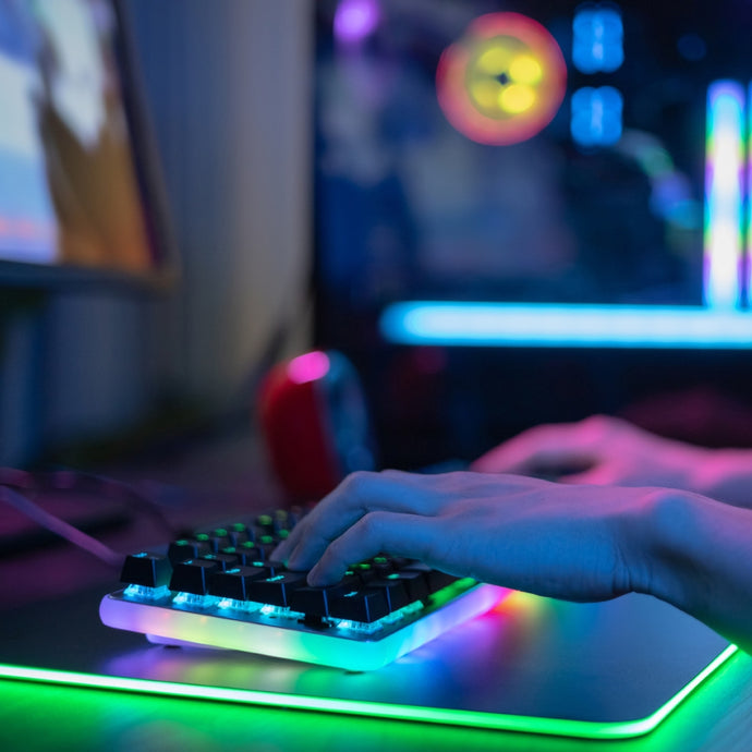 A keyboard with green lights mouse pad